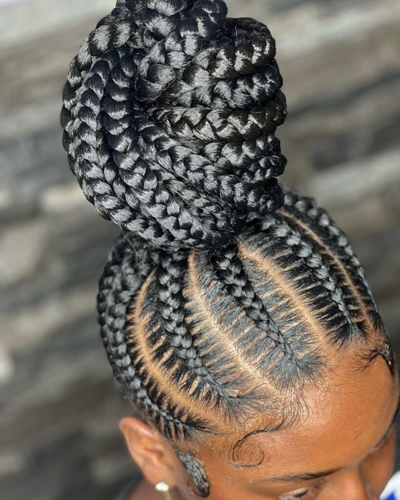 High braided bun with tight cornrows leading into a large coiled top knot.