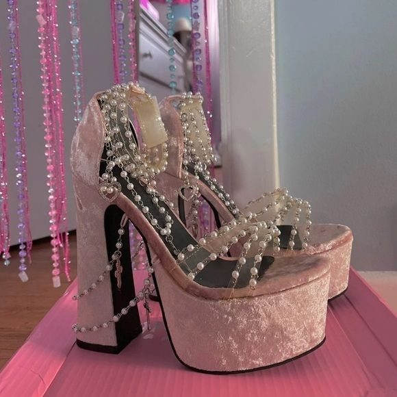 Pink crushed velvet platform heels decorated with pearl beads and silver charms.