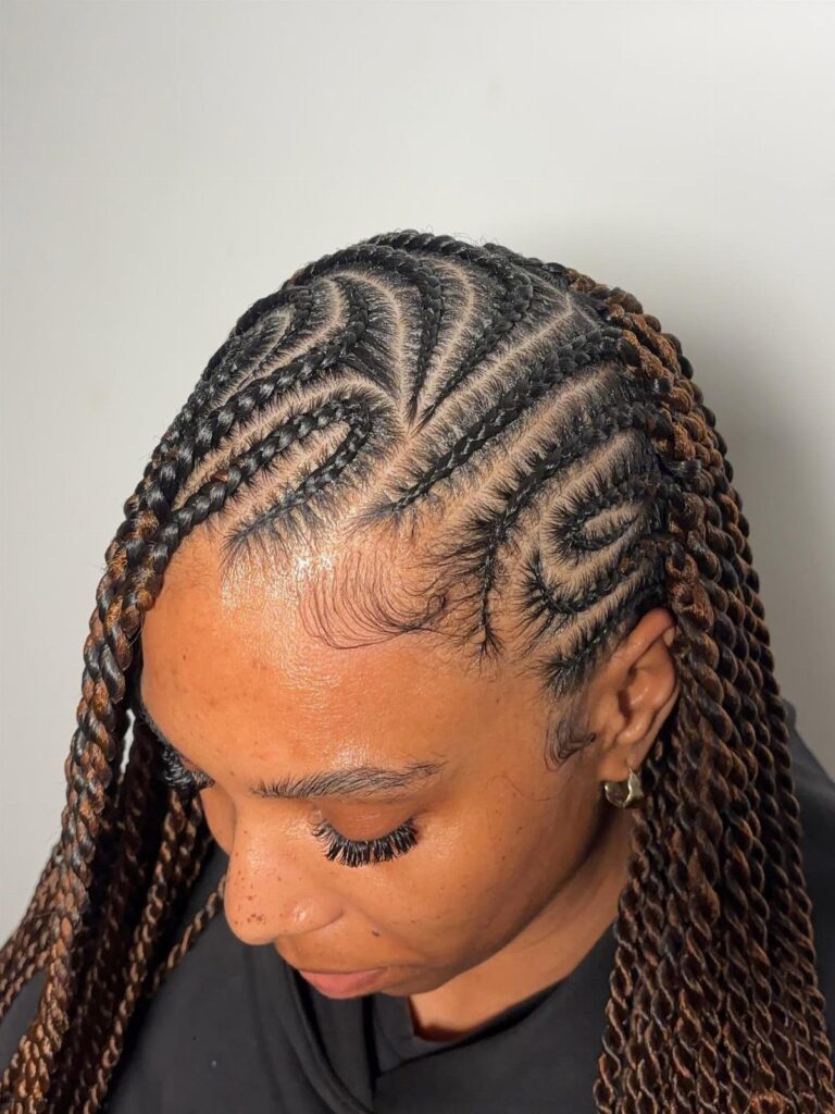 Woman with intricate cornrow patterns on scalp and long brown twisted braids.